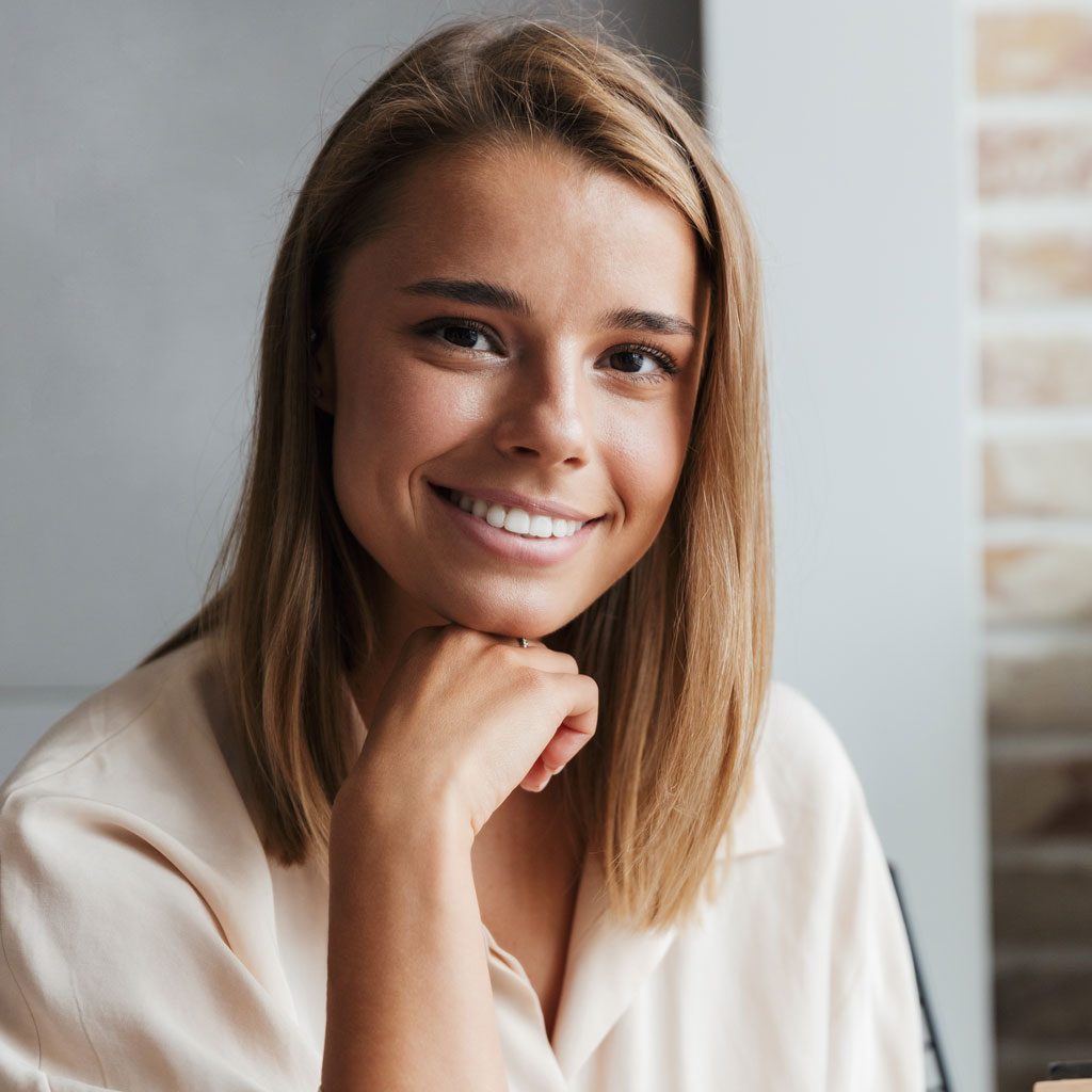 image-of-young-smiling-woman-reading-book-while-si-CFXP539.jpg